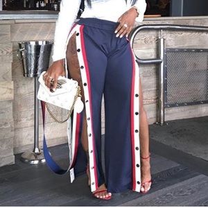 Red snap up track pants